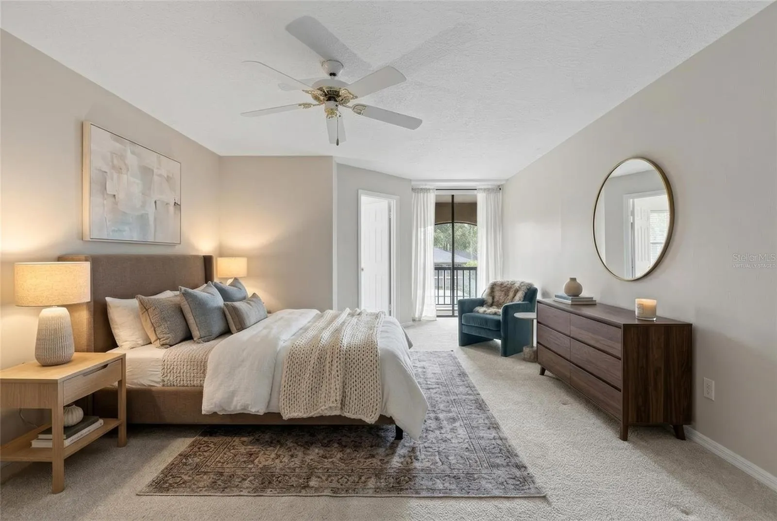 Virtually staged photo.  Primary bedroom has 2 closets and sliding glass doors that lead to the back porch.