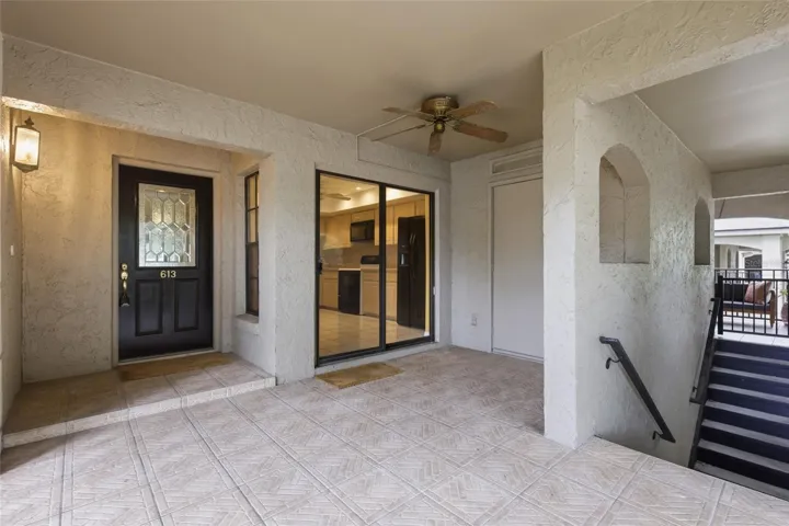 Front porch has space for patio furniture and there is a storage closet to the right.The sliding glass doors lead to the kitchen.
