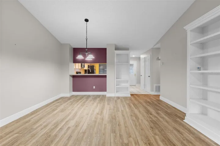 Living and dining room have newer luxury vinyl flooring and newly painted walls.