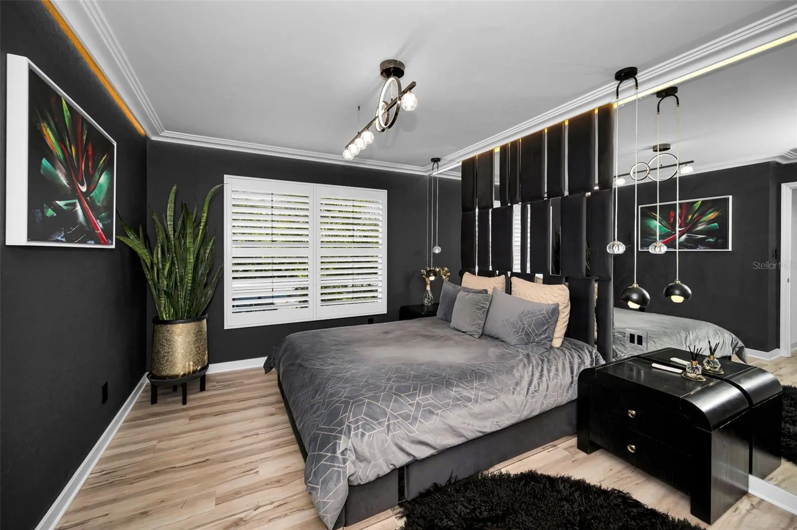 Primary suite with built in custom headboard and designer lighting