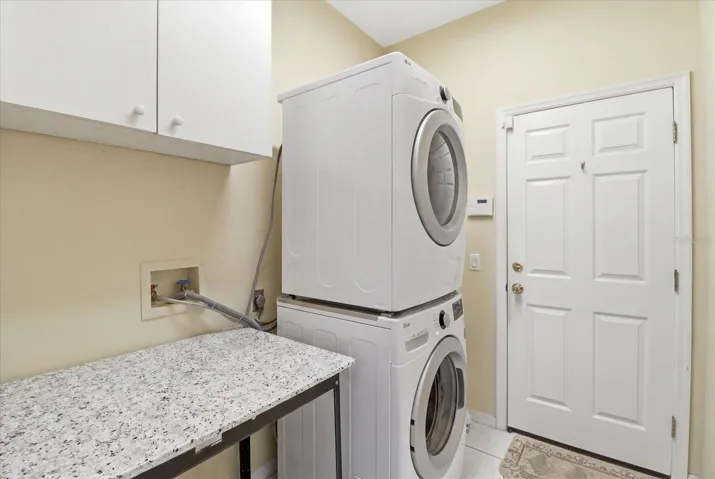Laundry Room w/ Utility Sink & Stacked Washer & Dryer