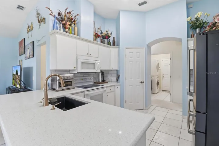 Freshly Painted Kitchen w/ Solid Surface Countertops, NEW White Subway Tile Backsplash, Breakfast Bar & Pantry Closet...Laundry Room Across the Hall