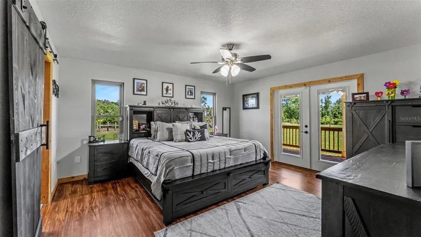 Primary Bedroom With French Doors to Back Wrap Around Porch