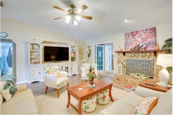 Open floorplan with FPL & wood floors in DR area.