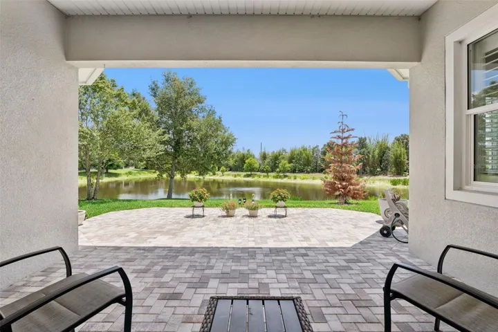 15' x 20' Covered Lanai w/ a brick paver patio overlooking a Pond