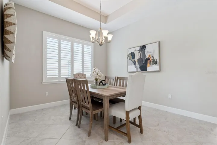 11'6" x 11' Dining Room w/ tray ceiling & Plantation style shutters