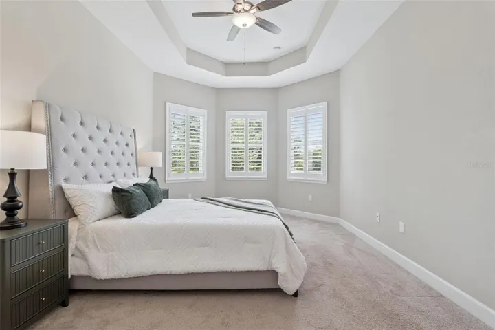 Primary Bedroom w/ a view to the Pond behind the home
