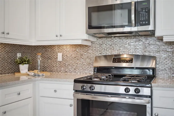 4-Burner natural gas range, Quartz countertops & Listello tile backsplash