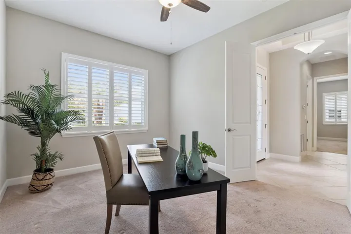 11' x 14' Den/Office w/ double doors, Plantation style shutters & a ceiling fan