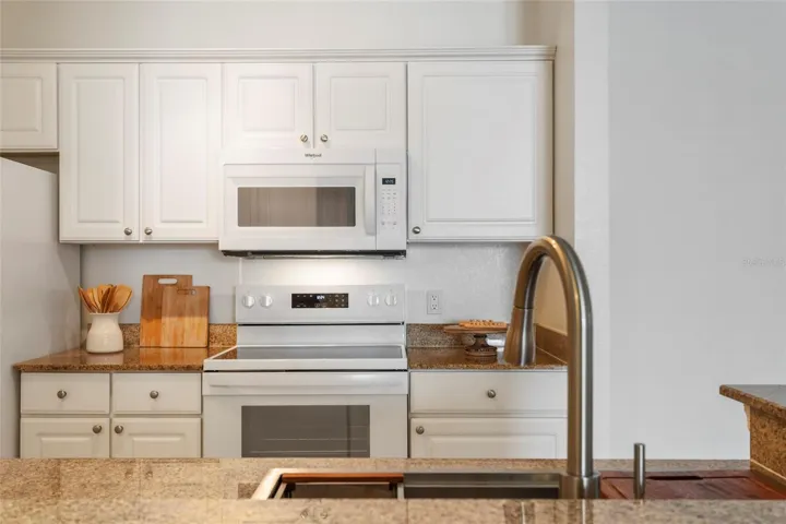 Plenty of storage in cabinets and drawers located on either side of range for cooking utensils.