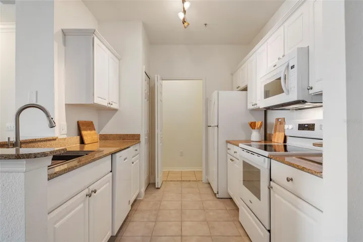 Nice long galley kitchen with view to living area and easy access laundry room with bi fold door to provide privacy from the laundry waiting to be done.