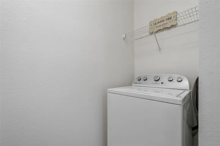 Washer and Dryer hook up with shelving above areas