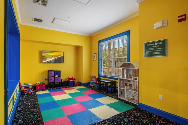 Tot room equipped with some distraction toys and television.