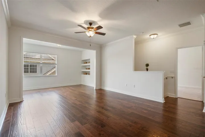 A view of alcove and living area. Note built in shelving area and double window providing lots of natural light!