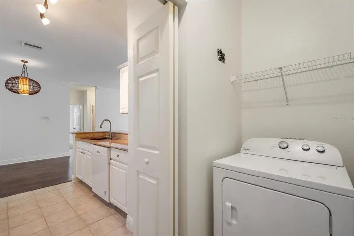 Washer and Dryer hook up in unit with shelving above both areas