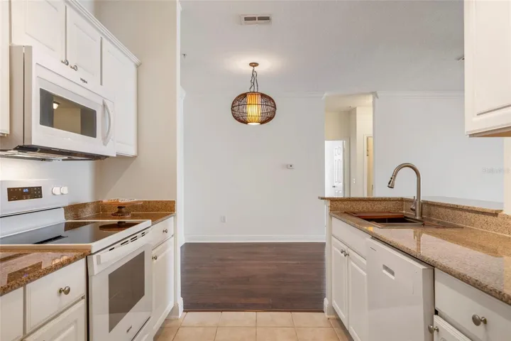 Brand new appliances have never been used. Range and microwave, fresh white cabinets.