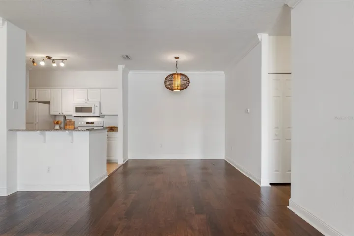 A closer view of dining area and updated lighting in dining and kitchen areas
