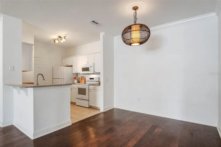 From the dining area into the kitchen. Breakfast bar can accommodate a couple of stools.