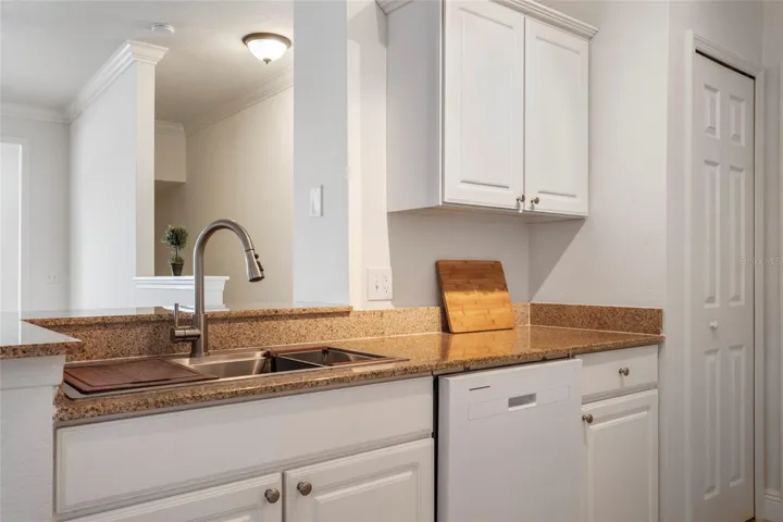 New sink and updated faucet, view from sink area into living room. Sink comes with a built in drying rack.
