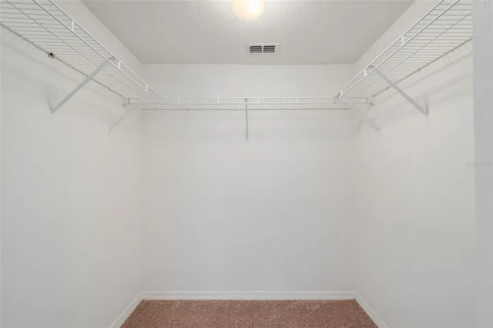 Primary bedroom walk in closet with ample storage