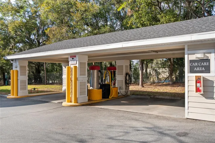 Community car wash station with hoses and vacuums.