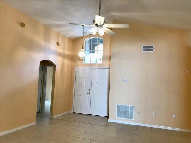 Living &amp; dining combo and double-door entry.  Bedroom 3 visible at left.