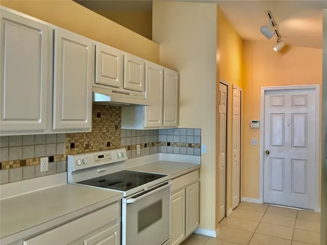Stove side of kitchen looking toward door to garage.