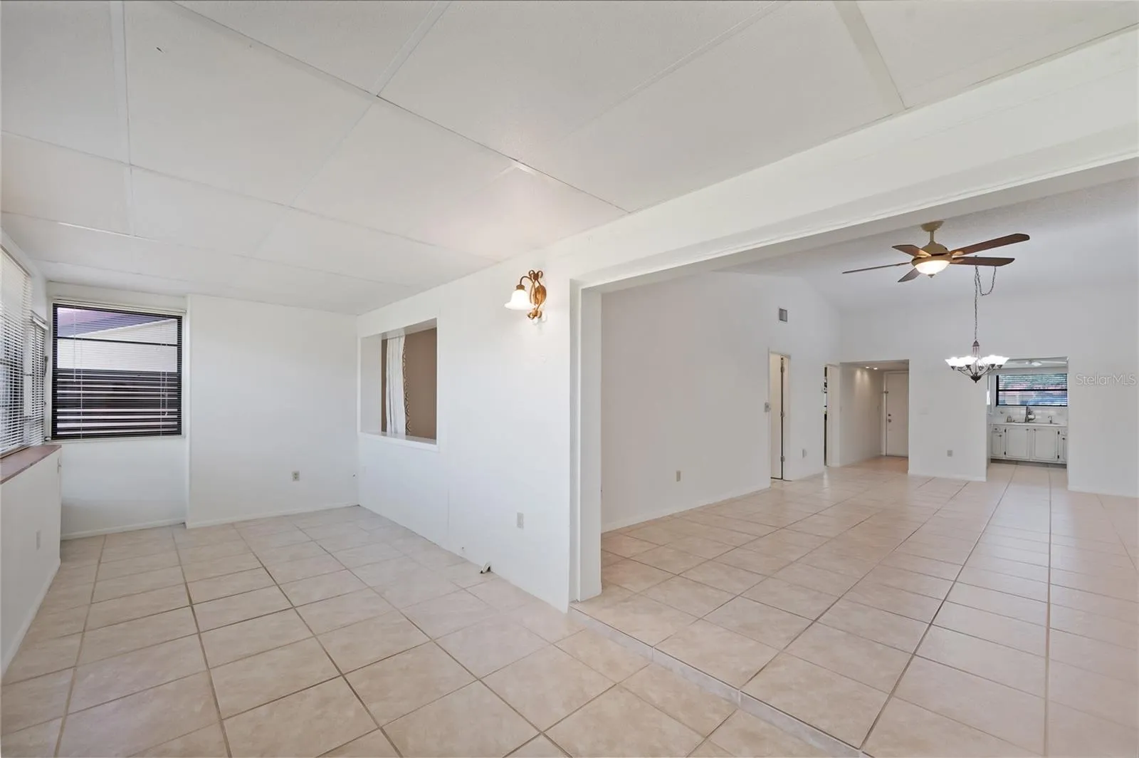 Spacious enclosed Florida room with windows just off the living room.