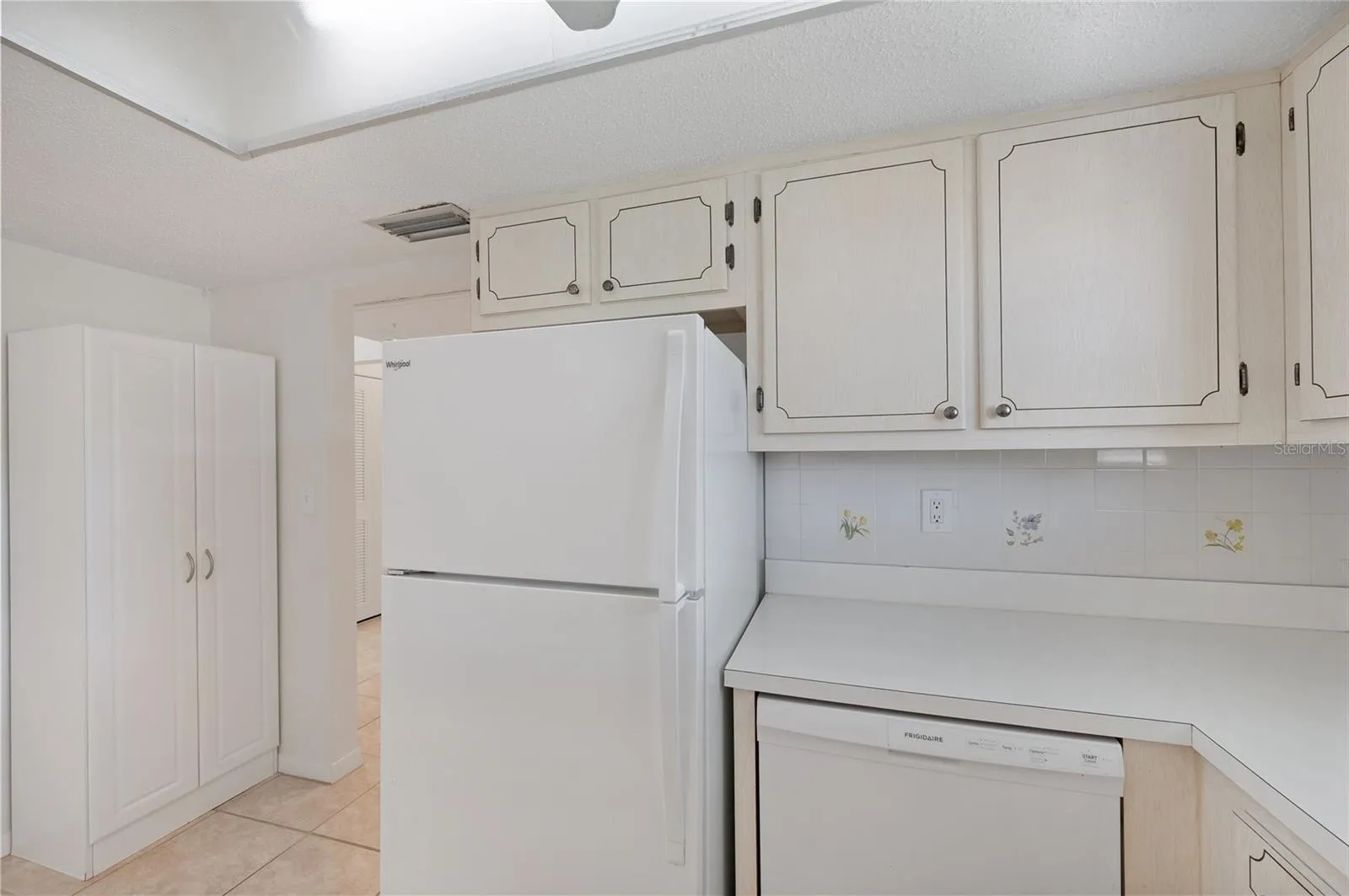Kitchen with full size refrigerator, dishwasher and electric range