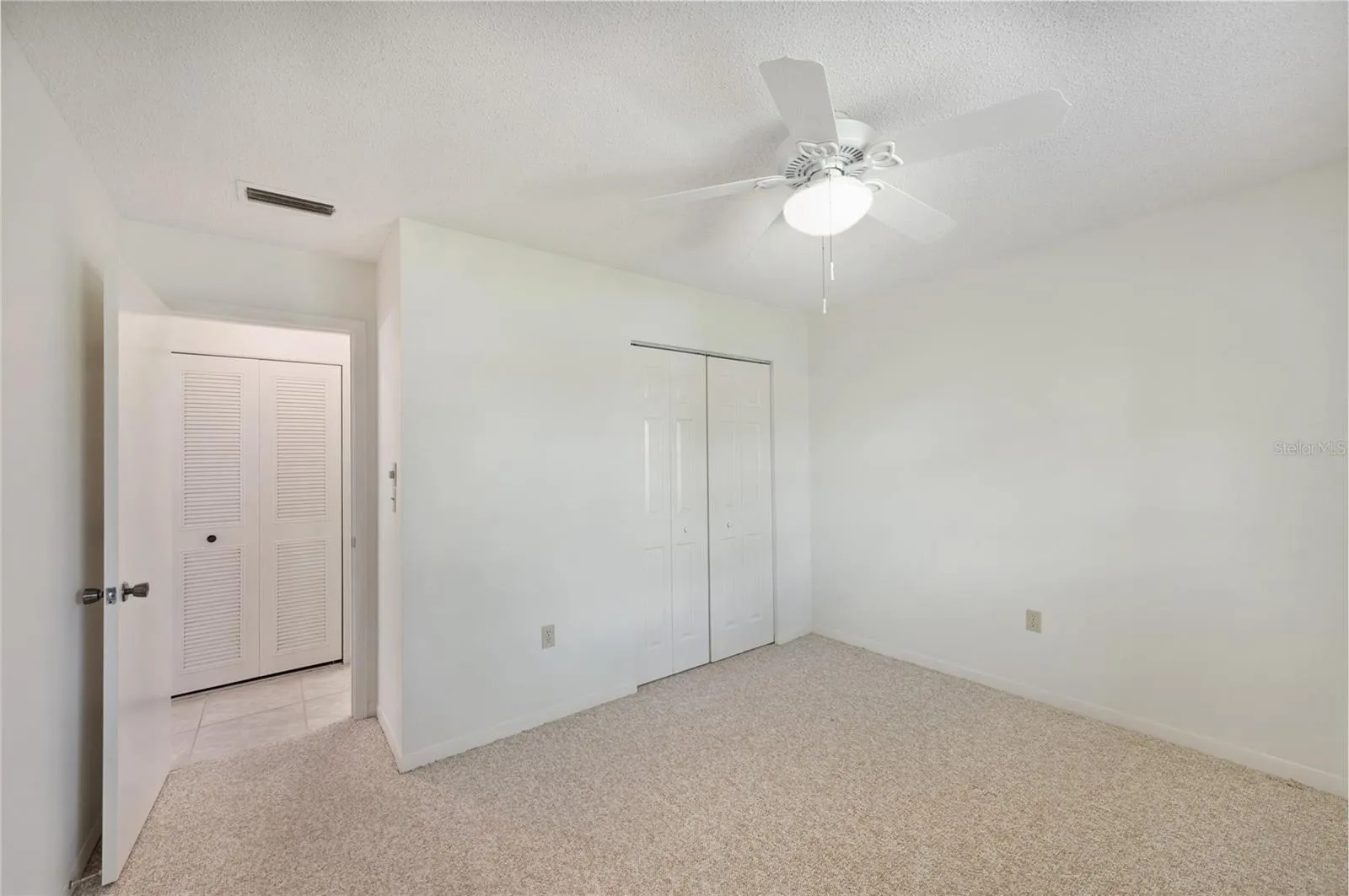 Guest bedroom with carpet and ensuite bathroom