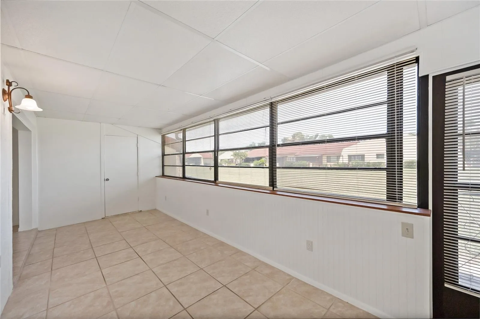 The Florida room has plenty of light from the wall of windows and nice views of greenspace. A nice size storage room is in the Florida room.