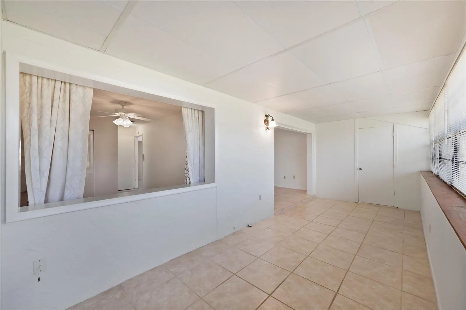 The primary bedroom has an opening which was most likely a window at one time to the Forida room which allows for greenspace views from the bedroom as well as the lanai