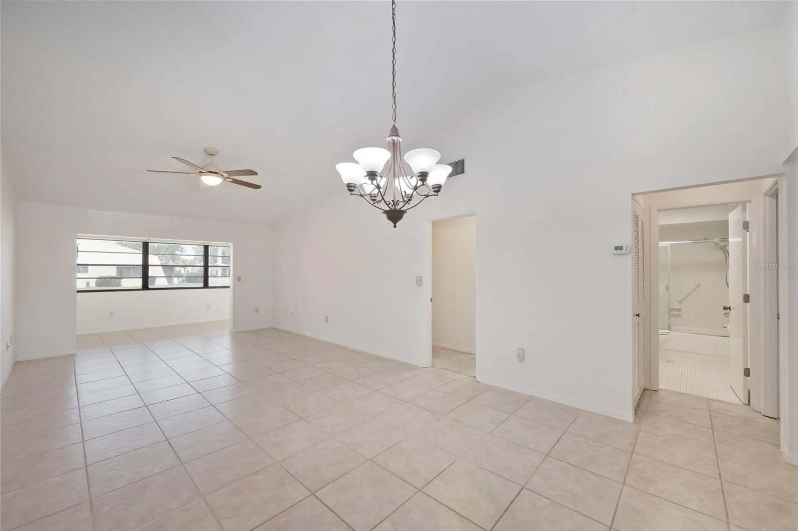 Spacious open floor plan with vaulted ceilings, tile floors and a large Florida room just off the living area