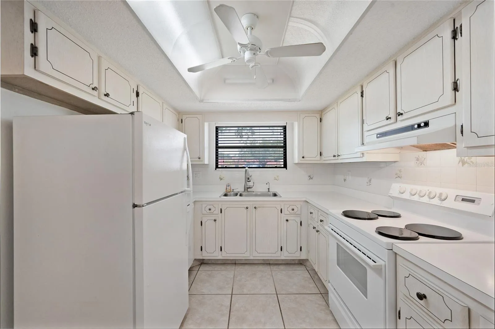 Kitchen with white appliances including a dishwasher