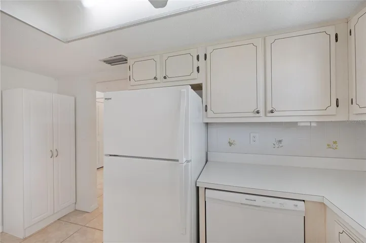 Kitchen with full size refrigerator, dishwasher and electric range
