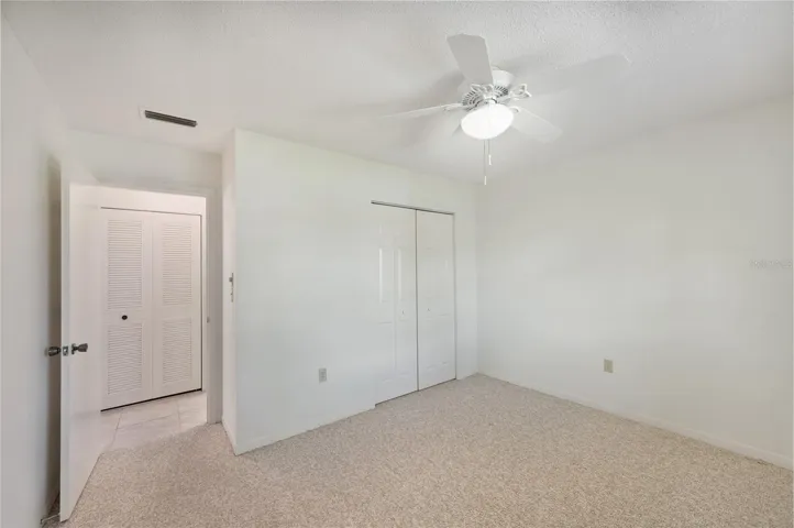 Guest bedroom with carpet and ensuite bathroom