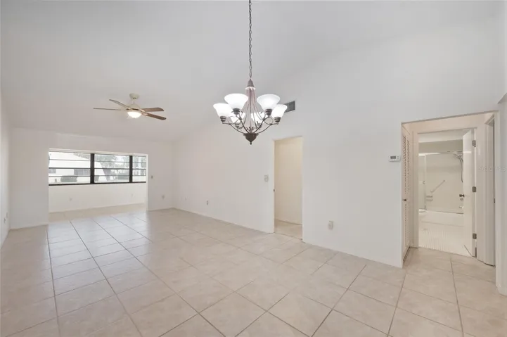 Spacious open floor plan with vaulted ceilings, tile floors and a large Florida room just off the living area
