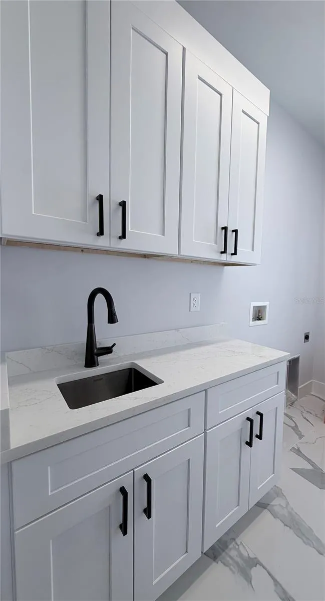 Laundry Room with Sink and Cabinets