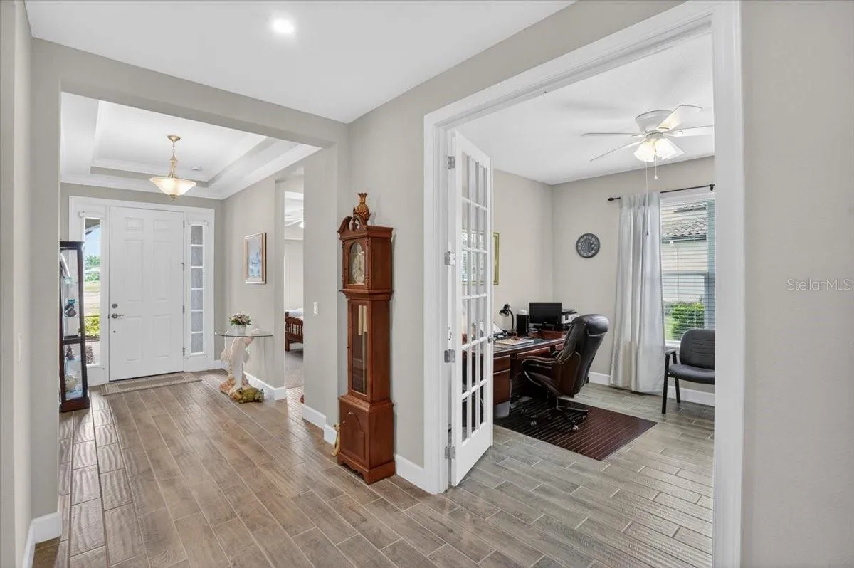 Walking towards the front door- the den with pocket doors is on the right side.