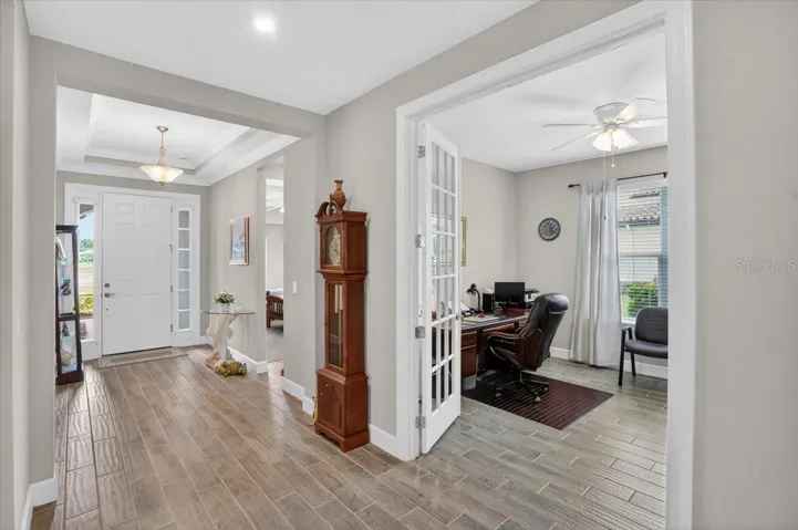 Walking towards the front door- the den with pocket doors is on the right side.