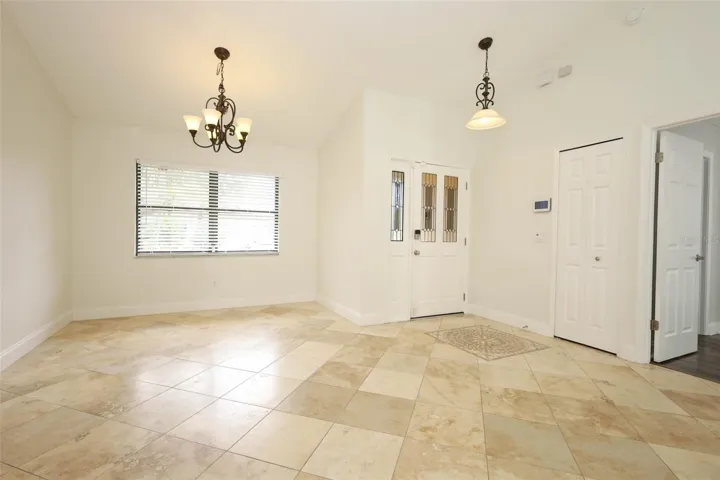 Foyer/dining room with Travertine tile flooring.