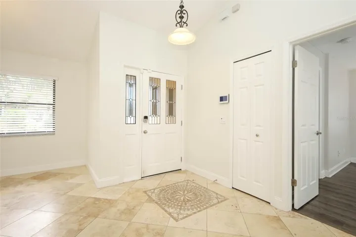 Foyer with Travertine tile flooring.