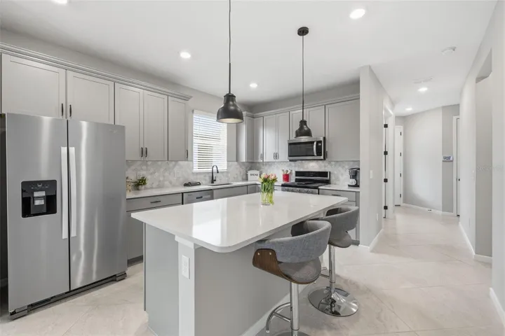 Chef's kitchen with 42 cabinets, ss appliances incl. gas stove, center island, Quartz countertops, marble backsplash