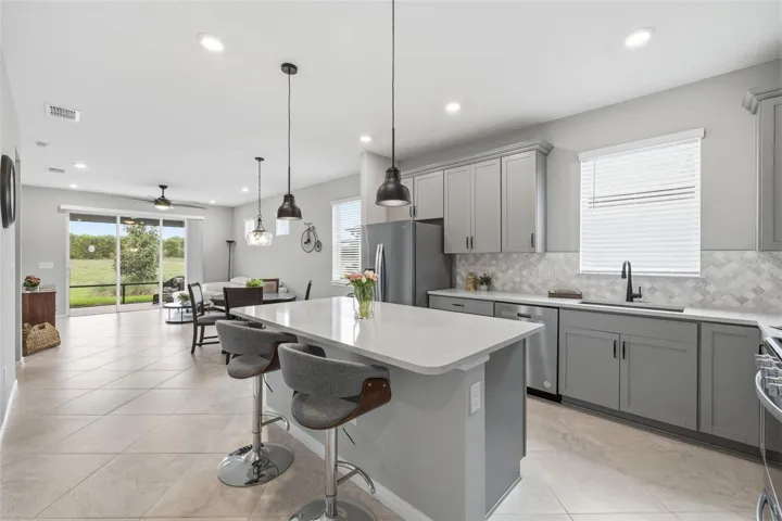 Welcoming breakfast bar with modern light fixtures