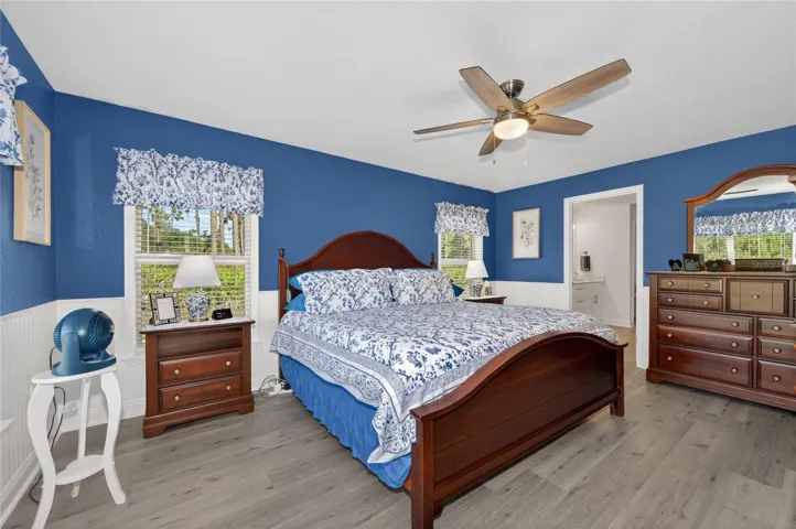 Notice wainscoting on primary bedroom walls. And molding on windows!