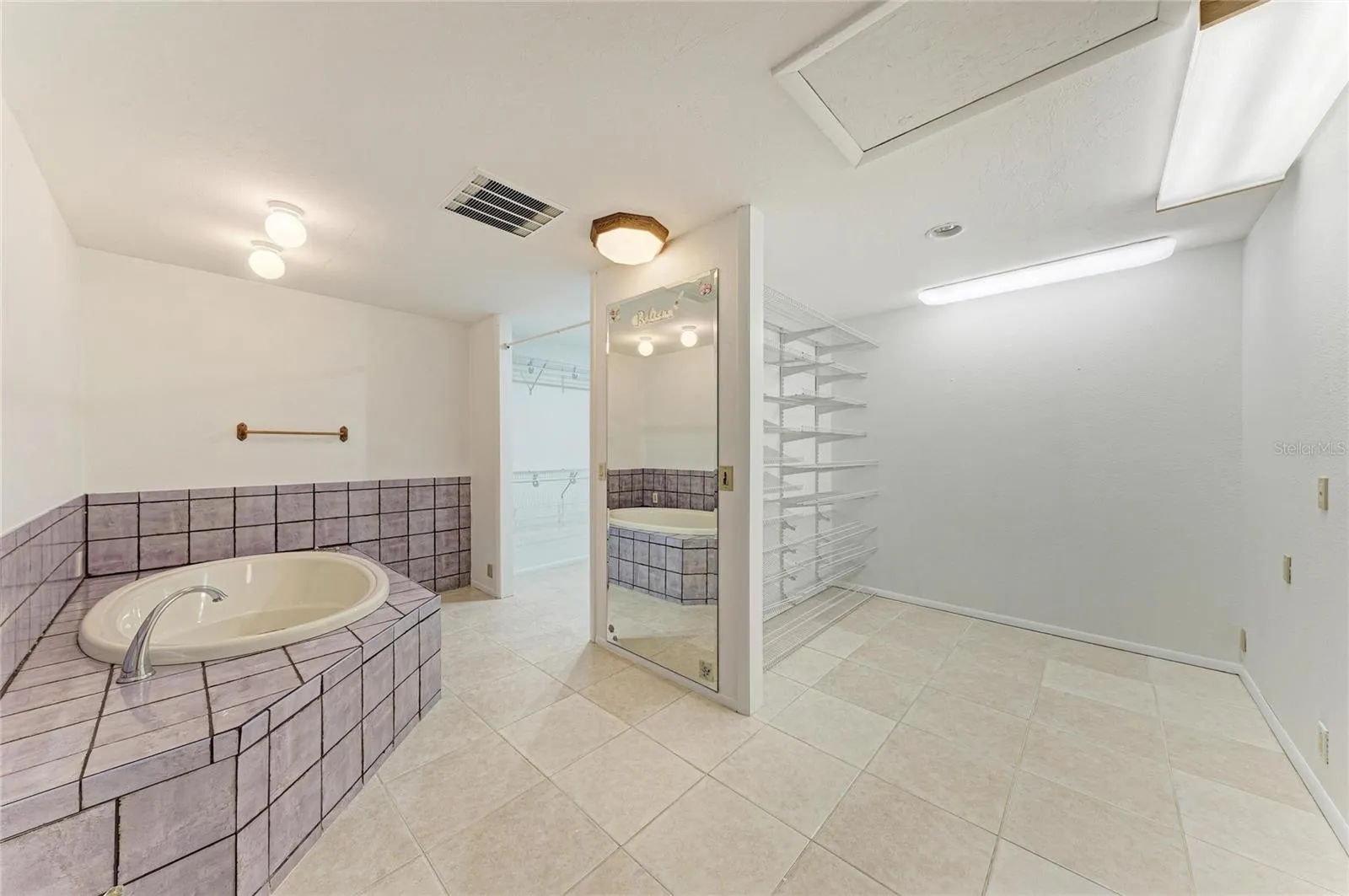 primary soaking tub with glamour closet