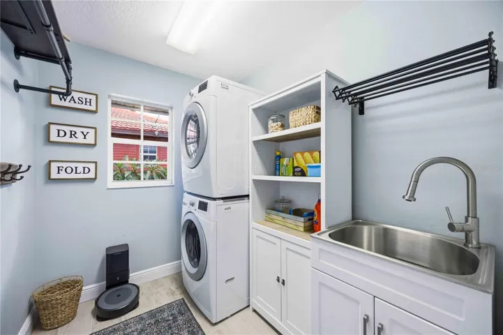 Large laundry room with cabinet and sink