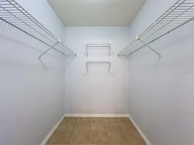 Walk in closet in primary bedroom