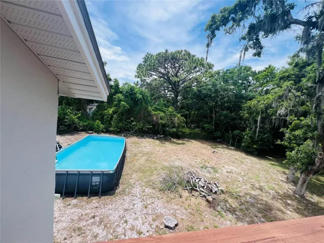 VIEW OF POOL AND YARD FROM UPPER DECK