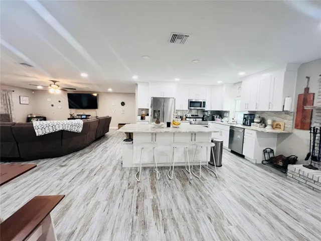 VIEW OF KITCHEN AND LIVING AREA FROM HALL WAY